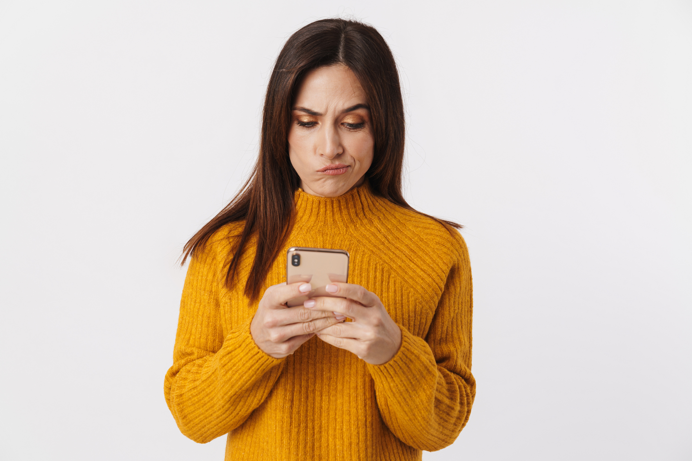 Image of Beautiful Brunette Adult Woman Frowning and Holding Cel
